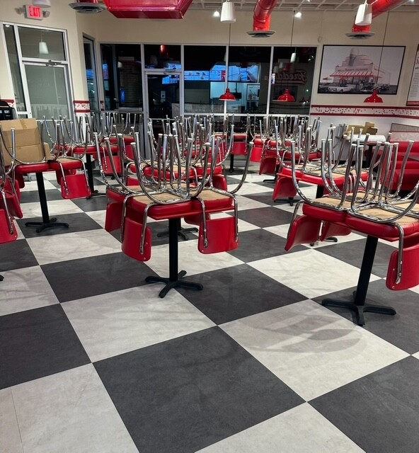 Rows of vacuumed workstation desks in an open-plan office